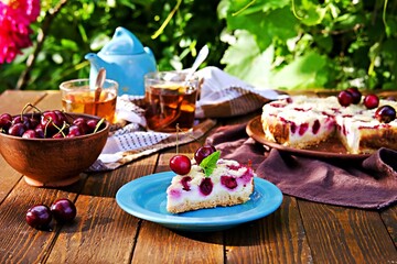 Obraz na płótnie Canvas Sliced shortcake with cottage cheese and cherry on a blue plate.