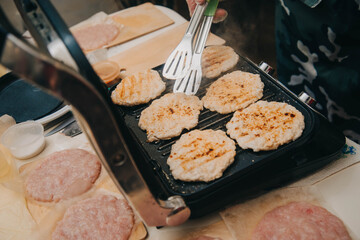 Chicken burger cutlets are fried on the electric grill