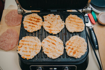 Chicken burger cutlets are fried on the electric grill