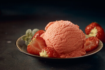 Tasty strawberry gelato scoop decorated with berries and served on table