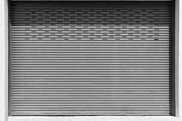 Fototapeta premium Closed Silver metal shutter garage door at home