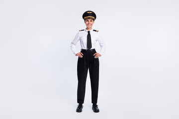 Photo of cheerful charming lady hands hips wear hat aviator uniform pants shoes isolated white color background © deagreez