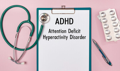 Paper with ADHD - Attention Deficit Hyperactivity Disorder, on a table, stethoscope and pills