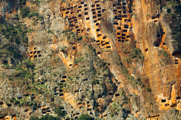 Impressive view of crag with carved tombs in ancient Lycian city of Pinara in Turkey