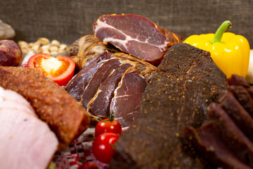 Assortment of cold cuts, a variety of processed cold meat products. On a wooden background