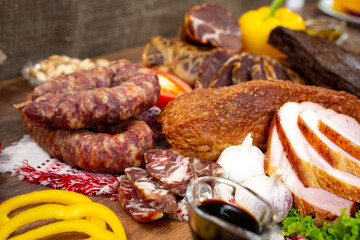 Assortment of cold cuts, a variety of processed cold meat products. On a wooden background