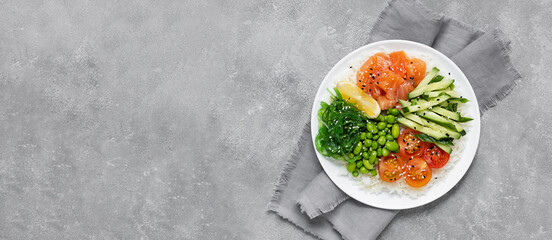 Poke salad of rice, salmon, cucumber, chuka seaweed, he beans, cherry tomatoes and sesame seeds