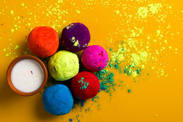 Celebrate indian festival holi, Multicolors ball on yellow background