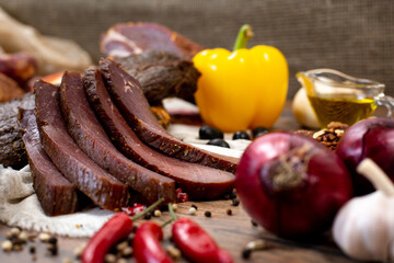 Assortment of cold cuts, a variety of processed cold meat products. On a wooden background