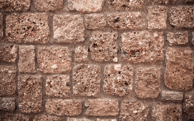 brown stone wall closeup, textured pattern, natural background