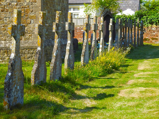 Stone crosses stand in a row near the church