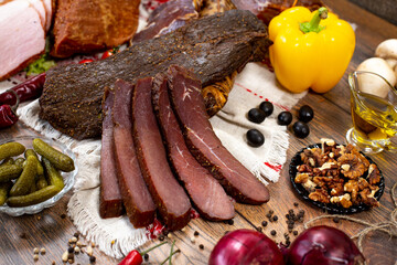 Assortment of cold cuts, a variety of processed cold meat products. On a wooden background