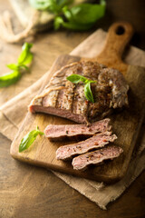 Delicious grilled beef steak with fresh basil