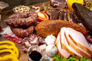 Assortment of cold cuts, a variety of processed cold meat products. On a wooden background