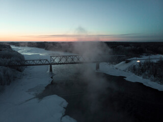 February, 2021 - Threshold. Railway bridge in the fog over the Onega river. Russia, Arkhangelsk region, Onezhsky district 