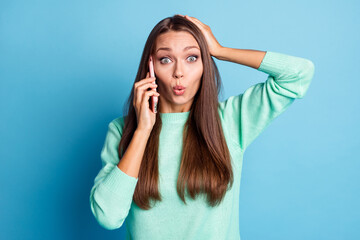 Fototapeta premium Portrait of nice stunned amazed brown-haired girl talking on phone incredible news pout lips isolated over bright blue color background