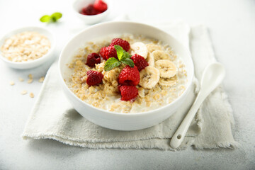 Healthy oatmeal porridge with fresh raspberry