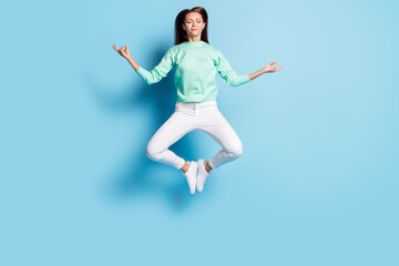 Fototapeta na wymiar Full length body size view of lovely calm focused girl jumping sitting lotus pose meditating isolated on bright blue color background