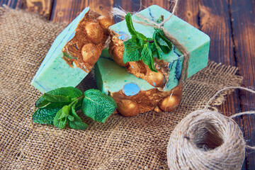 A fragrant green organic handmade soap decorated with mint leaves.