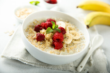 Healthy oatmeal porridge with fresh raspberry