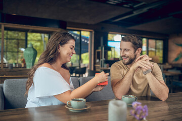 Happy woman with gift and caring man