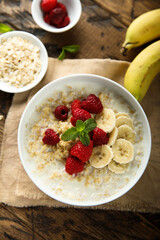 Healthy oatmeal porridge with fresh raspberry