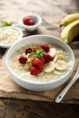 Healthy oatmeal porridge with fresh raspberry