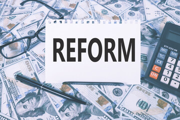 REFORM. text on white paper on the background of calculator and money bills