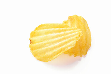 Yellow corrugated salted two potato chips on a white background, close up