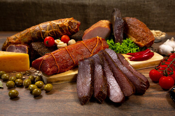 Assortment of cold cuts, a variety of processed cold meat products. On a wooden background