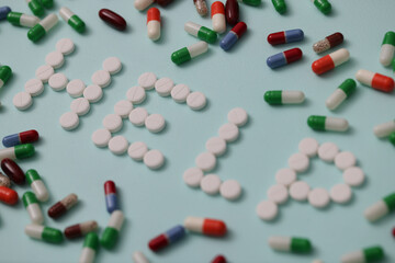 Help words made of white pills closeup. Medication treatment concept