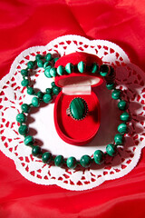 Jewelry from green malachite. Malachite beads and earrings in the studio