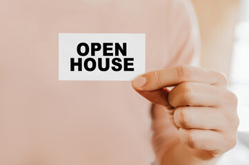Man holding a business card with Open House
