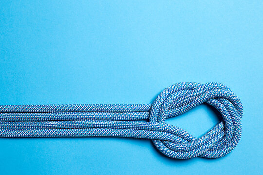 A knot on a blue rope on a blue background.