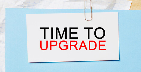 Text Time to upgrade on a white card on a blue background. Business concept