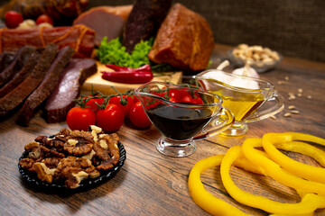 Assortment of cold cuts, a variety of processed cold meat products. On a wooden background