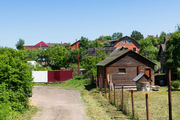 Fototapeta na wymiar Fragment of village with brick and wooden houses. Russia