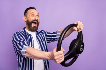 Profile side photo of impressed mature man drive fast car hold steering wheel isolated over purple...