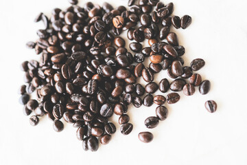 Roasted coffee beans placed on a white cloth.
