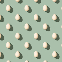 Pattern made of white eggs on pastel green background. Minimal food concept. Flat lay