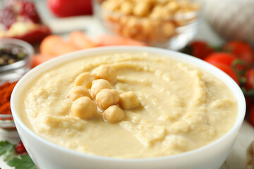 Bowl of tasty hummus, close up and space for text