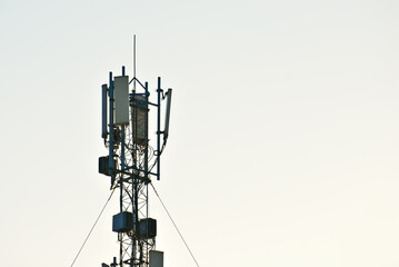 Tower with antennas on a background of blue sky. Television and radio antennas on the iron tower.