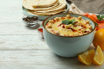 Concept of cooking hummus on white wooden background