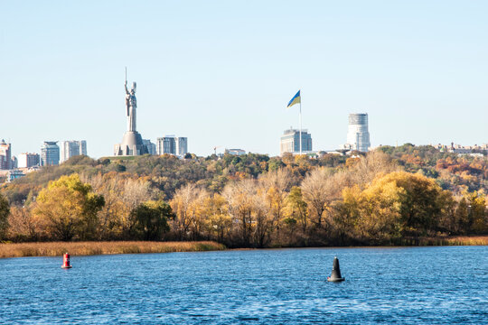 Kyiv, Ukraine 2020. Landscape view to Motherland Sculpture and Biggest Ukrainian Flag from left side Dniper river