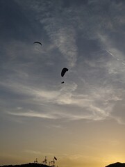 silhouette of a paraglider in sunset