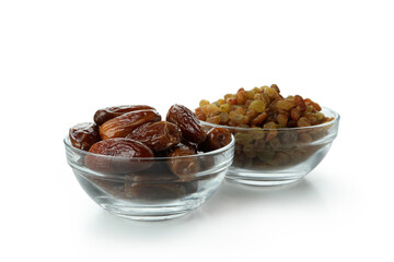 Bowls with dried dates and raisins isolated on white background
