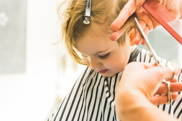 Fototapeta premium the little boy in a hairdressing salon