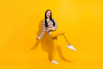 Fototapeta na wymiar Full size photo of young attractive lovely happy excited girl dancing enjoying weekend isolated on yellow color background
