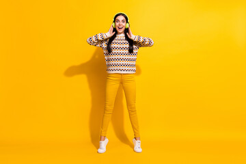 Fototapeta na wymiar Full size photo of young happy excited crazy amazed surprised girl listen music in headphones isolated on yellow color background
