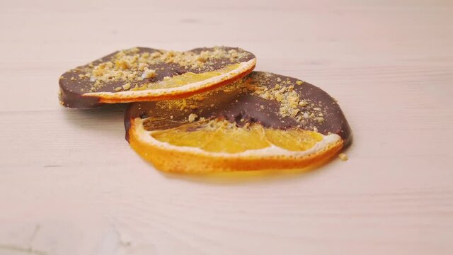 Close up of handmade chocolate covered dried orange slices on the table. Motion camera wiring